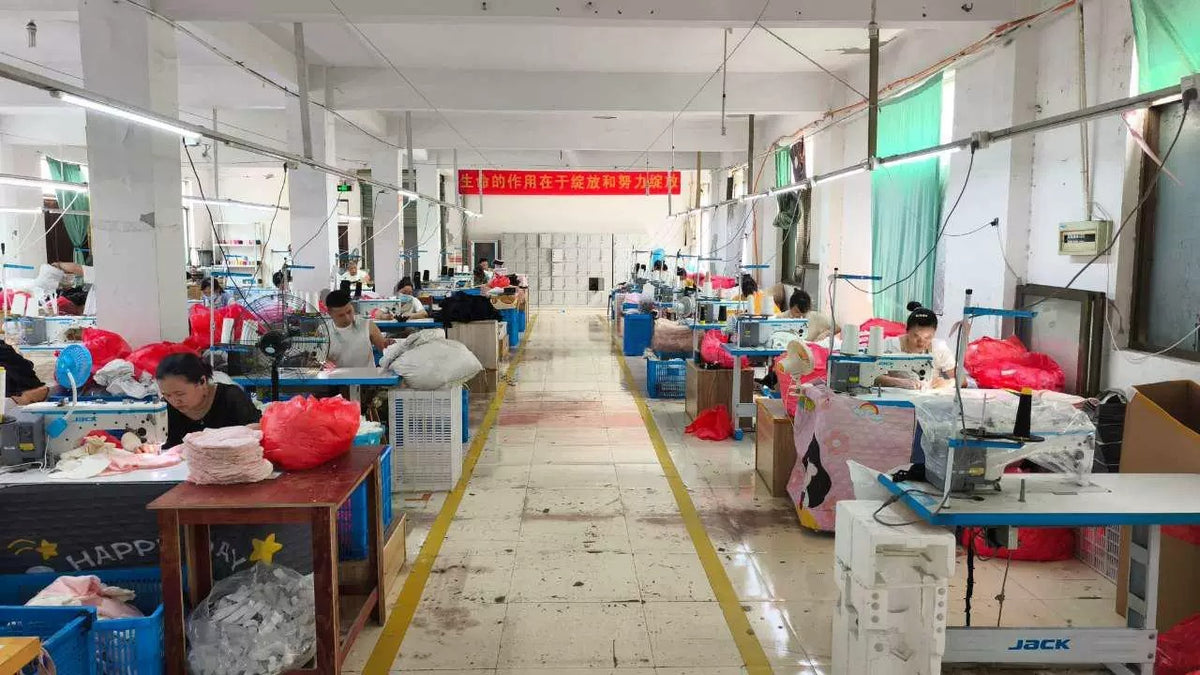 Production workshop – workers filling and assembling plush cushions